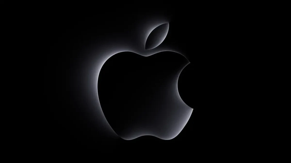 Siyah arka plan üzerinde ışıkla belirginleşen Apple logosu