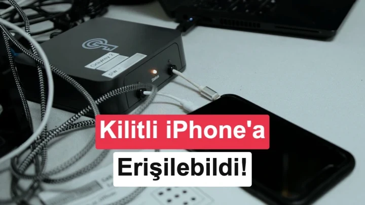 Bir masadaki adli bilişim cihazı ve yanında duran iPhone