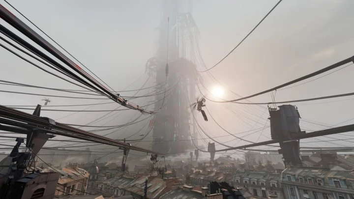 Half-Life evrenindeki City 17’de, binaların üzerinden geçen kablolar ve uzakta yükselen bir yapı
