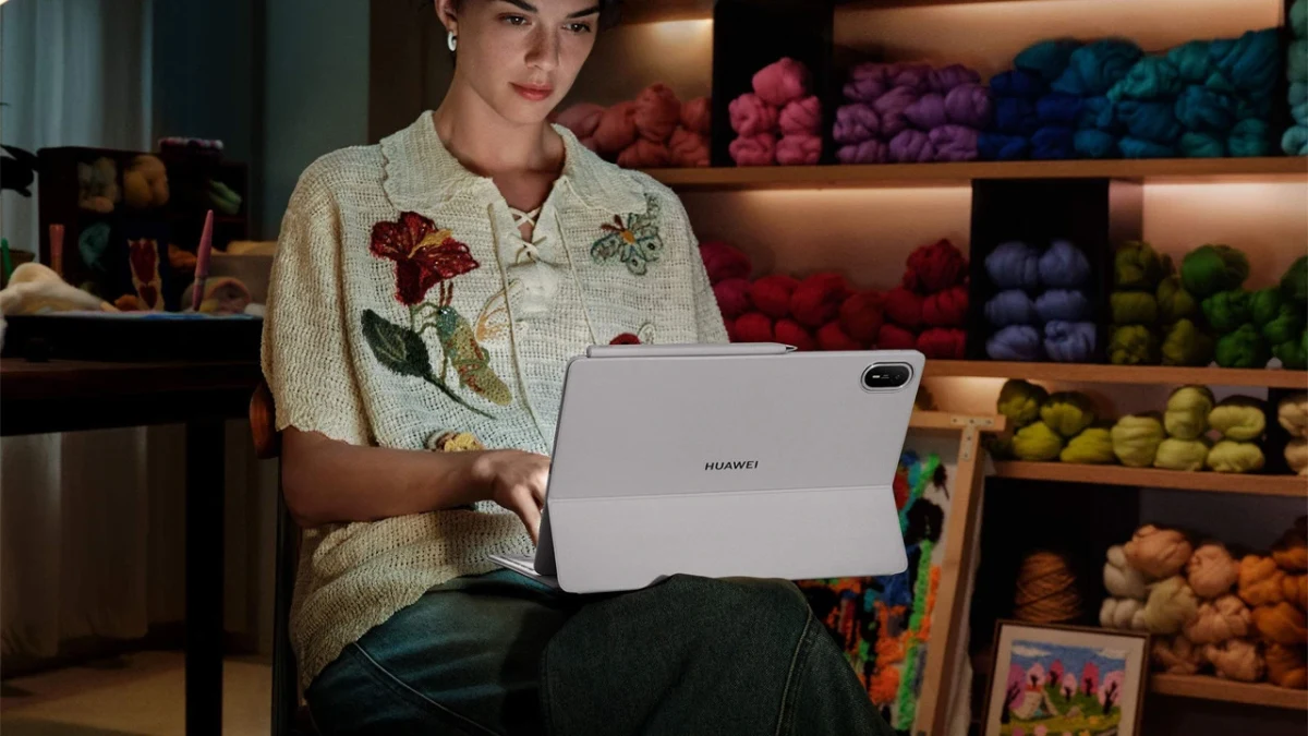 Bir kadın, örgü malzemeleriyle dolu bir dükkânda Huawei tablet kullanıyor.