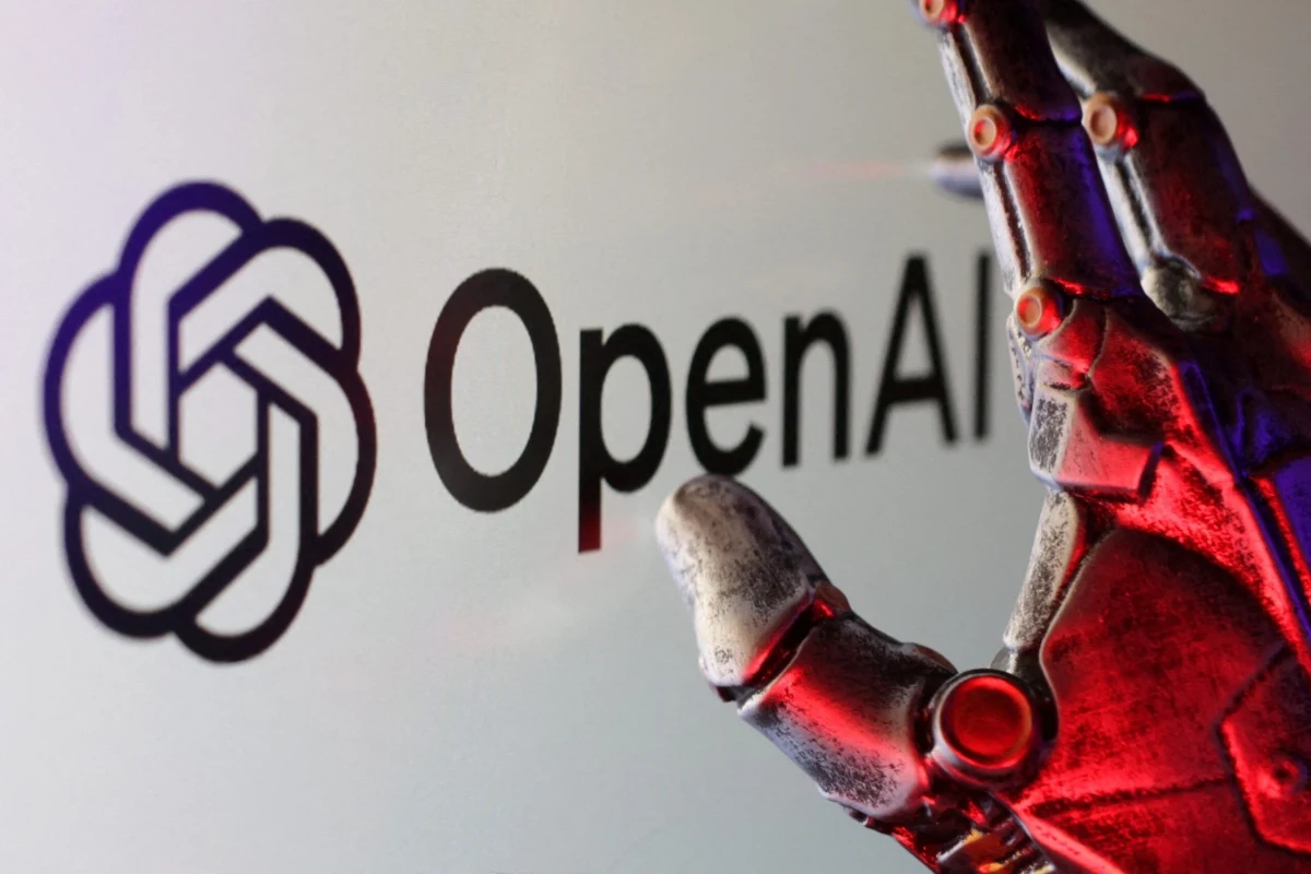 OpenAI logosunun yanında kırmızı ışıklarla aydınlatılmış robot eli