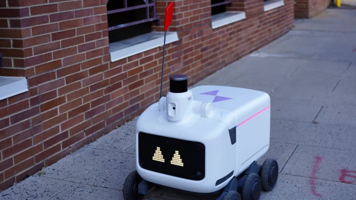 Kaldırım üzerinde duran tekerlekli otonom teslimat robotu
