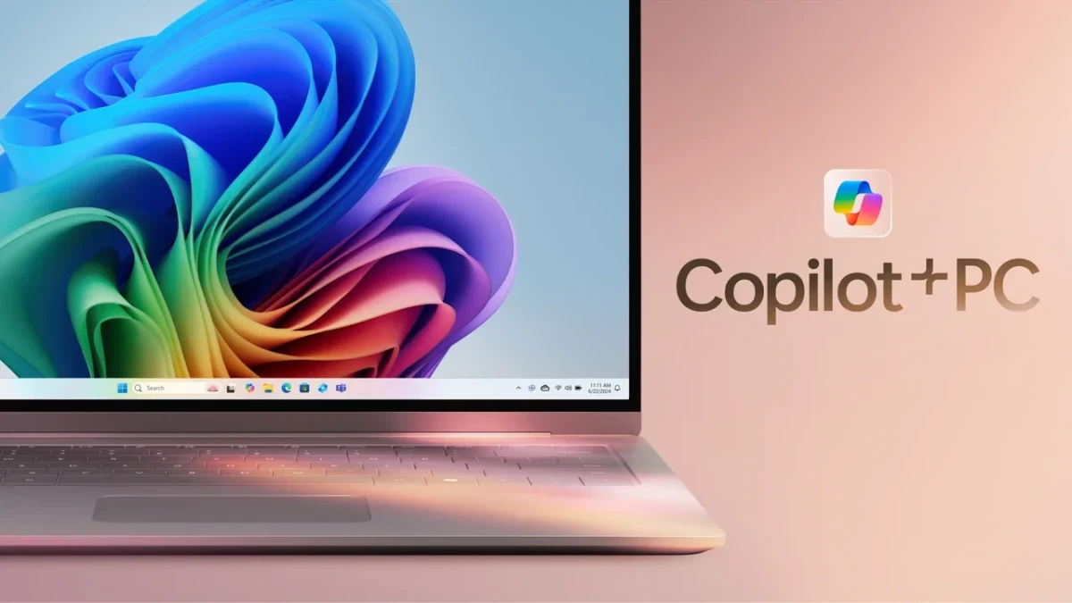 Windows 11 ekranı görünen bir dizüstü bilgisayarın yanında Copilot+ PC yazısı