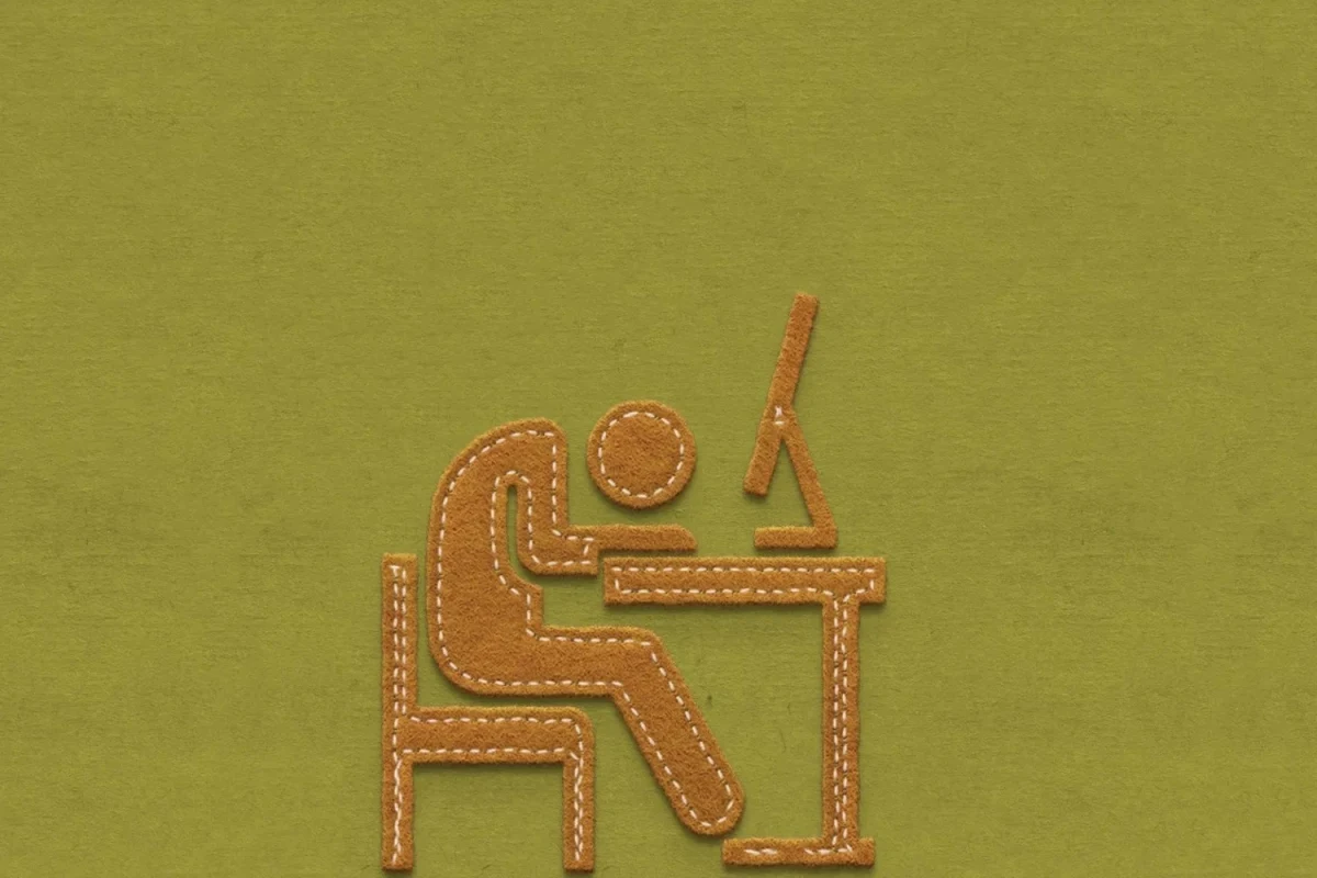 Masa başında çalışan bir kişiyi simgeleyen dikişli figür